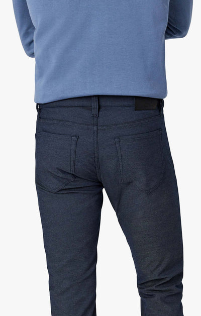 Back view of a person wearing 34 Heritage Courage Coolmax straight-leg jeans and a blue long-sleeve shirt.