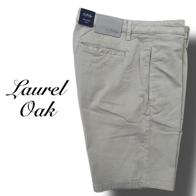 The 34 Heritage Nevada Soft Touch Shorts for men are light khaki, made from Soft Touch fabric, and feature a back pocket, belt loops, a dark waistband label, and "Laurel Oak" text on the left.