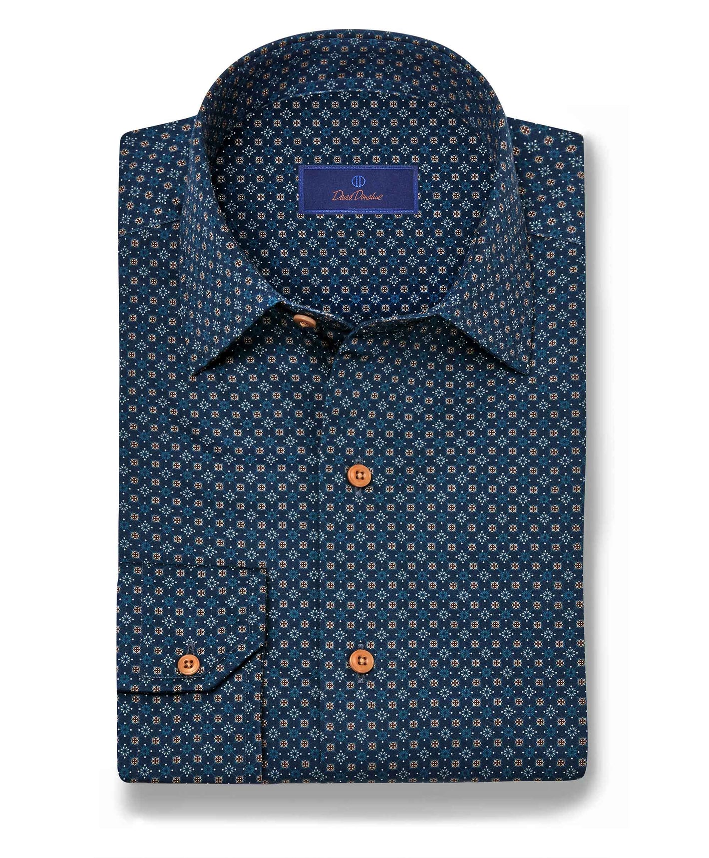 The David Donahue Micro Print Sport Shirt (CBSM11209) features a trim fit, long sleeves, navy micro geometric blue and white print, brown buttons, and a visible inner collar brand label.