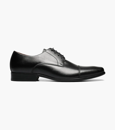 The Florsheim Postino Plain Ox Black Smooth is a black leather dress shoe with a low heel and lace-up closure, designed for all-day comfort. Shown in side profile on a white background.