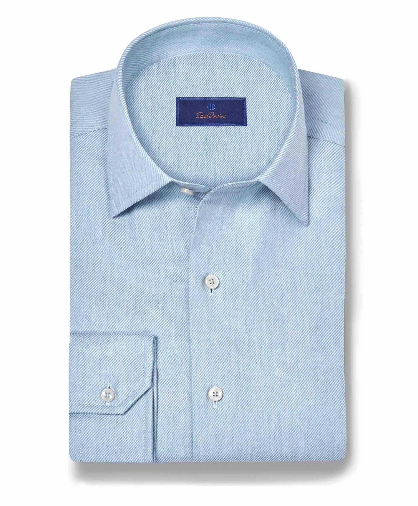 A neatly folded David Donahue Cashmere Blend Shirt CBSM11101 in light blue, with a spread collar and chest pocket, is displayed on a white background.