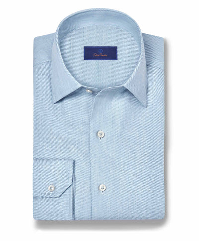 A neatly folded David Donahue Cashmere Blend Shirt CBSM11101 in light blue, with a spread collar and chest pocket, is displayed on a white background.
