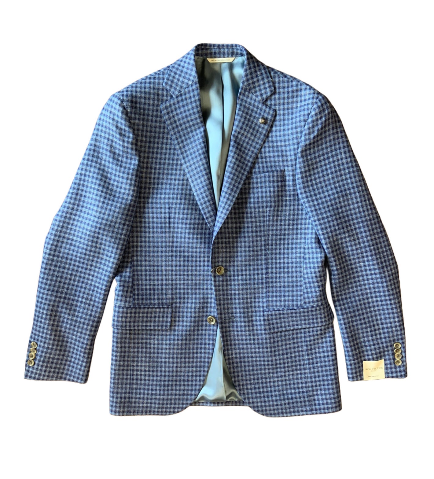 The Jack Victor Sports Coat Gibson 1251417 is a blue and black checkered men's wool blazer with light blue lining, two buttons, front pockets, and cuff button details. Displayed on a white background, it's perfect as a casual business blazer for any occasion.