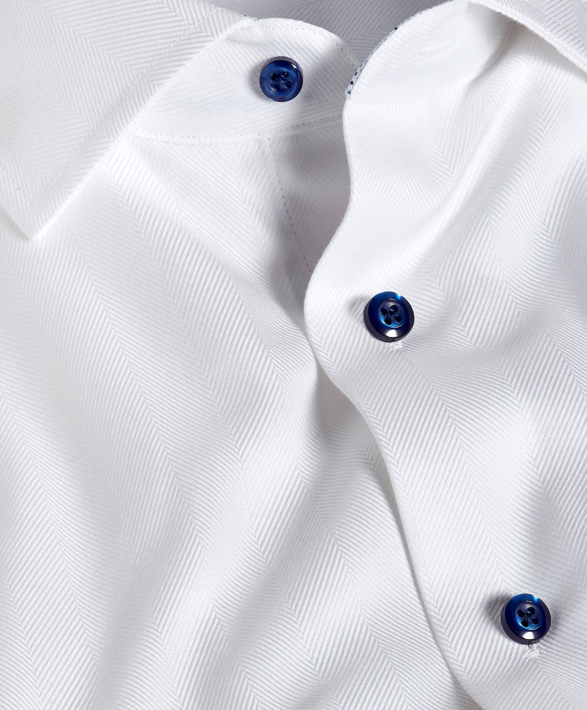 Close-up of the David Donahue Contrast Herringbone Solid Dress Shirt TBMS13100 in white with blue buttons, made from Pima cotton and tailored for a trim fit.