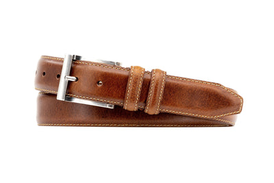 The Martin Dingman Bill Water Buffalo Leather Belt, handcrafted in America with visible stitching and a silver buckle, is coiled on a white background.