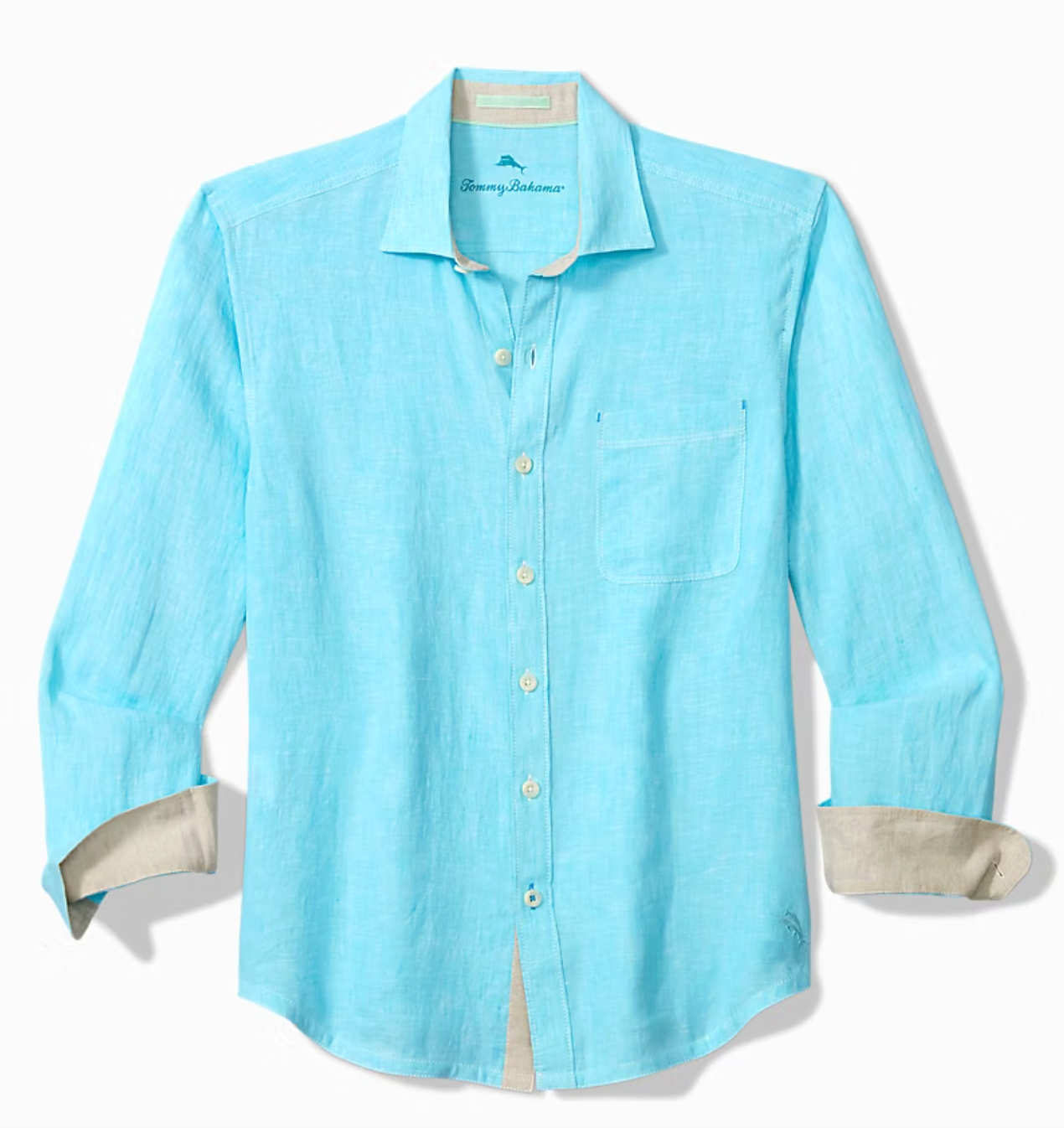 The Tommy Bahama Paradise Breezer Linen Shirt is a light blue, long-sleeve, button-up shirt with a chest pocket, beige inner cuffs, and subtle contrast stitching by Tommy Bahama, shown against a plain background.
