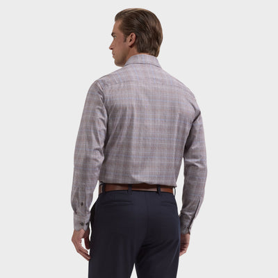 A man stands with his back to the camera, wearing the Bugatchi James Plaid Sport Shirt KF9278K60—a long-sleeve, wrinkle-resistant plaid shirt from Bugatchi—paired with dark trousers against a plain light background.