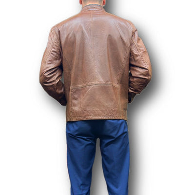 A person is shown from the back wearing a Missani Leather Jacket 392834 and blue pants against a white background.