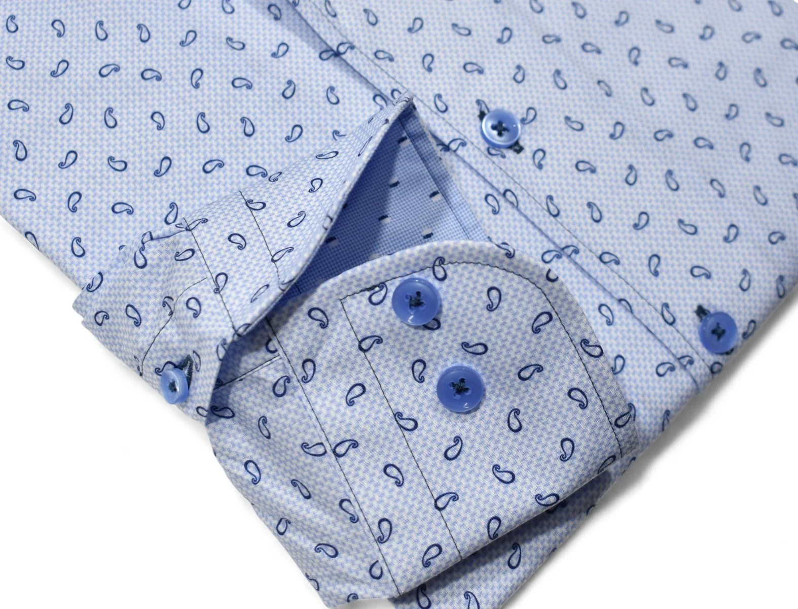 Close-up of the Marcello Brickell Paisley Sport Shirt W123 sleeve in soft-touch light blue cotton, featuring blue buttons and a detailed cuff with part of the placket.