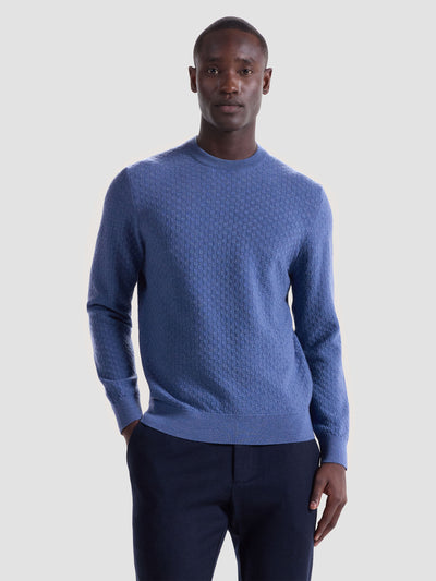 A man faces the camera with a neutral expression, wearing dark pants and a Bugatchi Basketweave Crew Neck Sweater HH202CN1 by Bugatchi against a plain background.