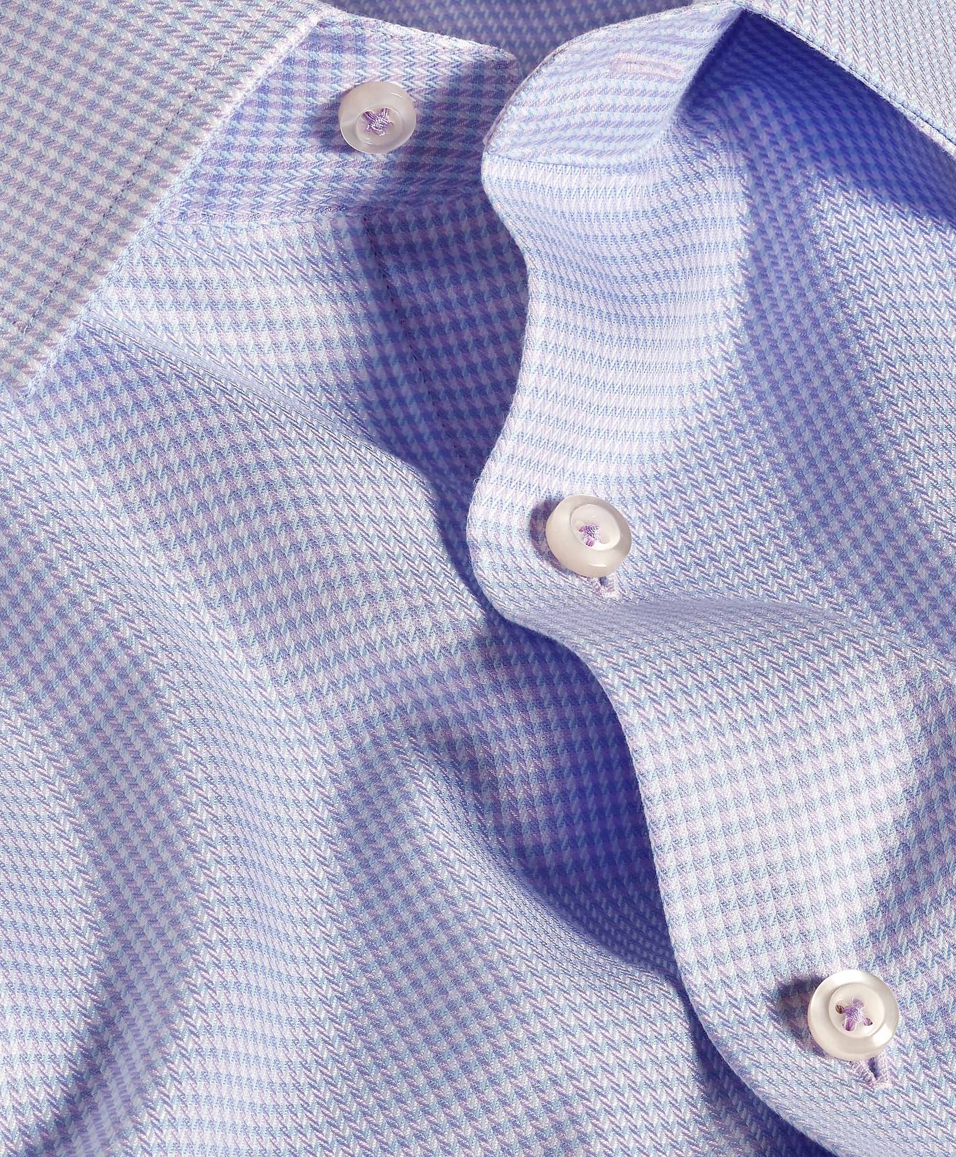 Close-up of the David Donahue OP Herringbone Silk Blend Dress Shirt TBSP12822455, a premium light blue shirt with a small houndstooth pattern, white buttons, and part of the collar visible.