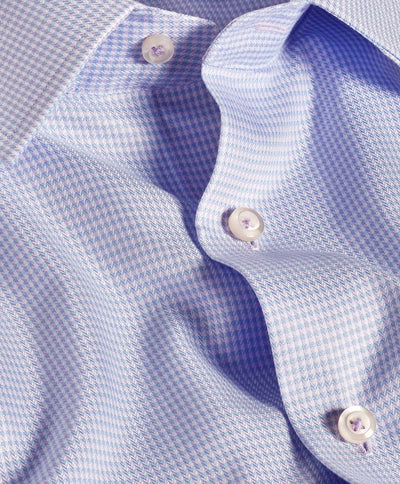 Close-up of the David Donahue OP Herringbone Silk Blend Dress Shirt TBSP12822455, a premium light blue shirt with a small houndstooth pattern, white buttons, and part of the collar visible.