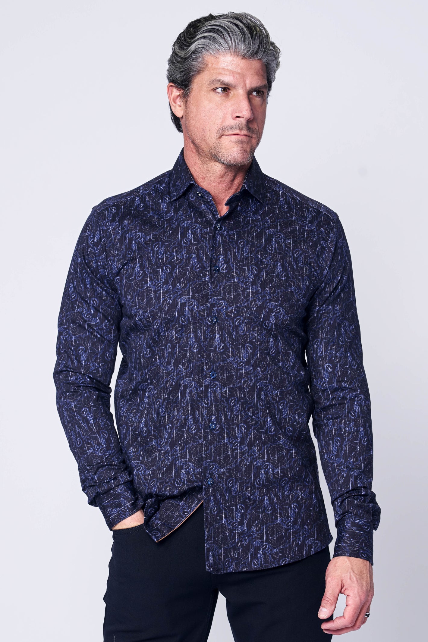 A man with gray hair models the 7 Downie St. Big & Tall Sport Shirt LS 108, paired with black pants, highlighting its modern fit against a plain light background.