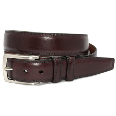 The Torino Italian Burnished Kipskin Leather Belt by Torino, with a silver buckle, is rolled up and displayed on a white background.