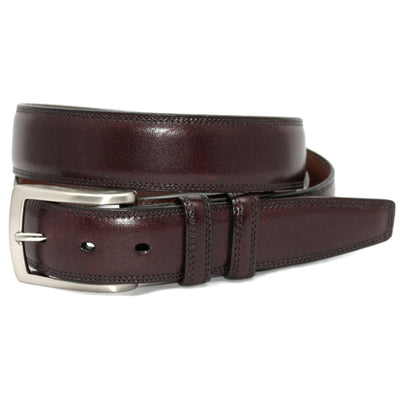 The Torino Belt Smooth by Torino, shown rolled up with a silver rectangular buckle against a white background, features classic styling in dark brown Italian leather.
