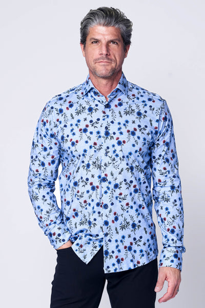 A middle-aged man with gray hair wears a 7 Downie St. Amore Big & Tall Sport Shirt Multi, featuring a tailored fit and floral pattern in blue tones, paired with black pants, standing against a plain white background.
