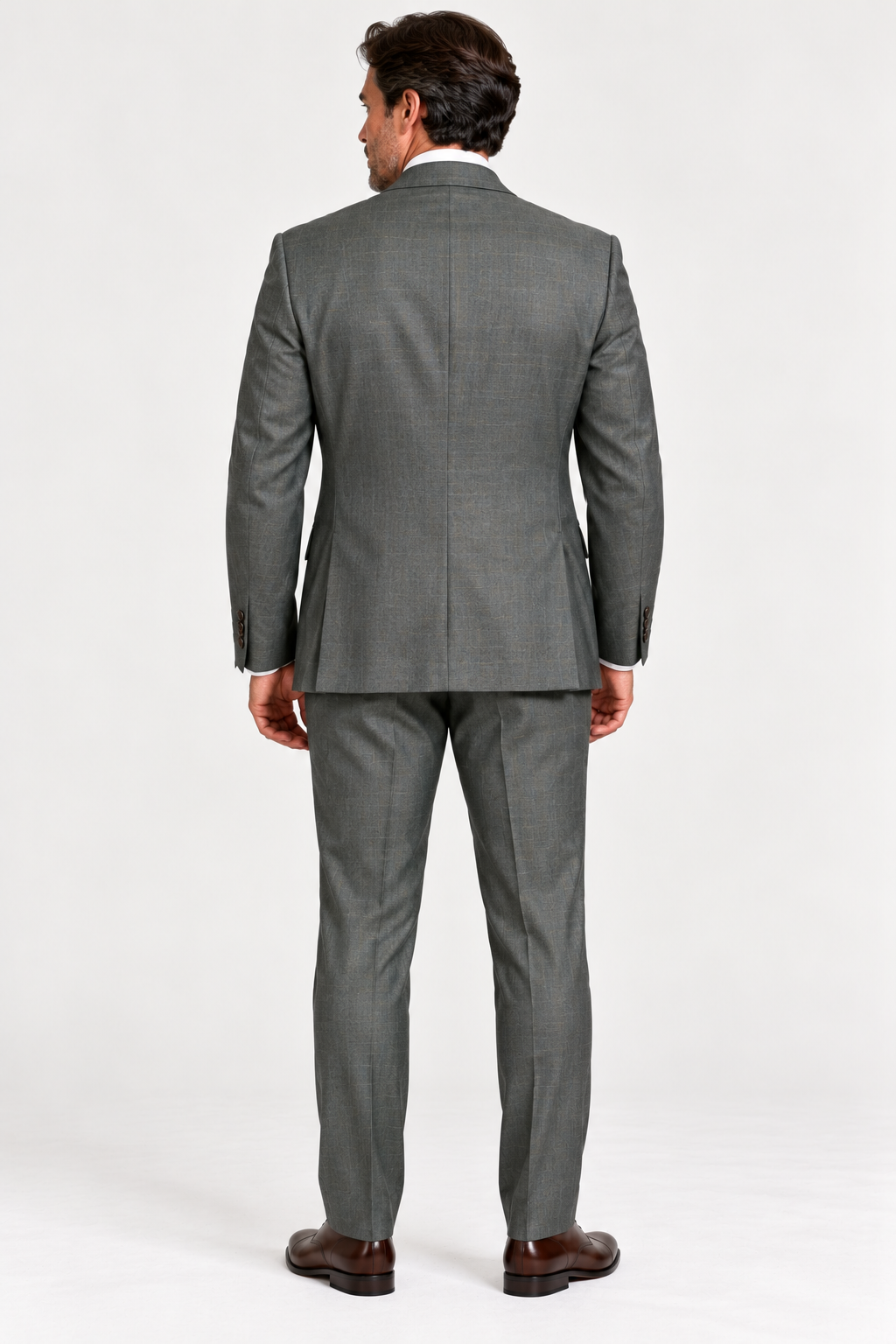 Back view of a man wearing a Jack Victor Engel Olive Slim Fit Suit 3262602 and brown leather dress shoes.