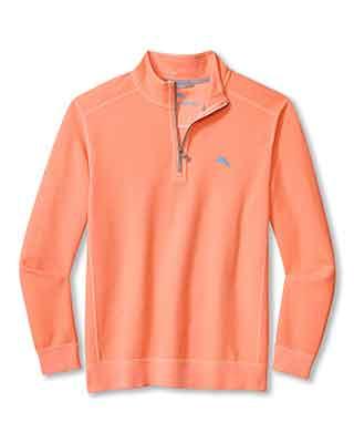 The Tommy Bahama Montego Beach 1/2 Zip is a light orange, long-sleeve knit pullover featuring a small blue logo on the left chest, with ribbed cuffs and hem.