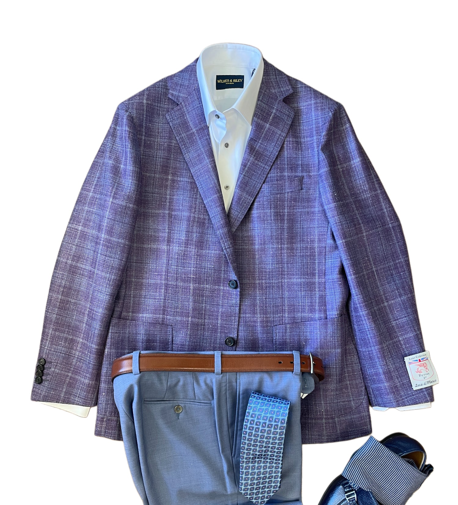 A light blue button-up shirt with the Byron Luca Soft Sport Coat 9547 in purple plaid, blue trousers, a brown belt, and a blue patterned tie, all from Byron, are laid out flat.