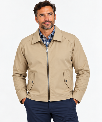 Man wearing the Hart Schaffner Marx Felix Commuter Jacket 6214 in beige over a blue plaid shirt and navy pants, hands in pockets, against a plain white background.