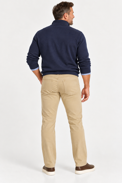 Man with his back to the camera in a navy sweater, light blue shirt, and beige Alberto PIPE 1607 Diamond Brushed Stretch Cotton Jeans by Alberto, on a white background.