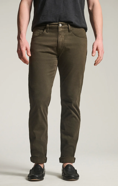 A person wearing 34 Heritage Courage Twill Straight Leg Pants in cactus green, a dark t-shirt, and black loafers stands facing forward with hands relaxed at their sides.