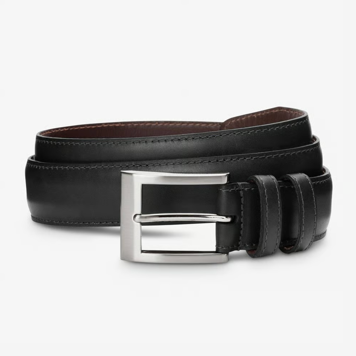 The Allen Edmonds Wide Basic Belt by Allen Edmonds is a black Italian calfskin leather dress belt with visible stitching, rolled up and featuring a rectangular silver buckle, handcrafted in America and displayed on a plain background.
