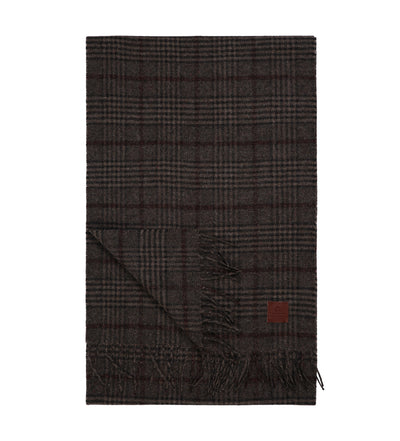 The Amanda Christensen Wool Check Scarf 440705 features a classic check pattern in dark brown and gray with fringed edges and a small leather patch—a stylish, essential winter accessory from Amanda Christensen.