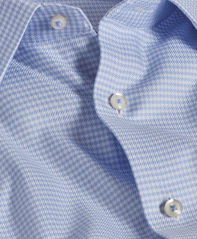 Close-up of the David Donahue Twill Check TBSP10800: a light blue checkered US Pima cotton dress shirt by David Donahue, featuring a spread collar, barrel cuffs, and white buttons.