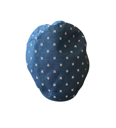 The Wigens Cap 101414 by Wigens is blue with a small white floral pattern, shown from above against a white background.