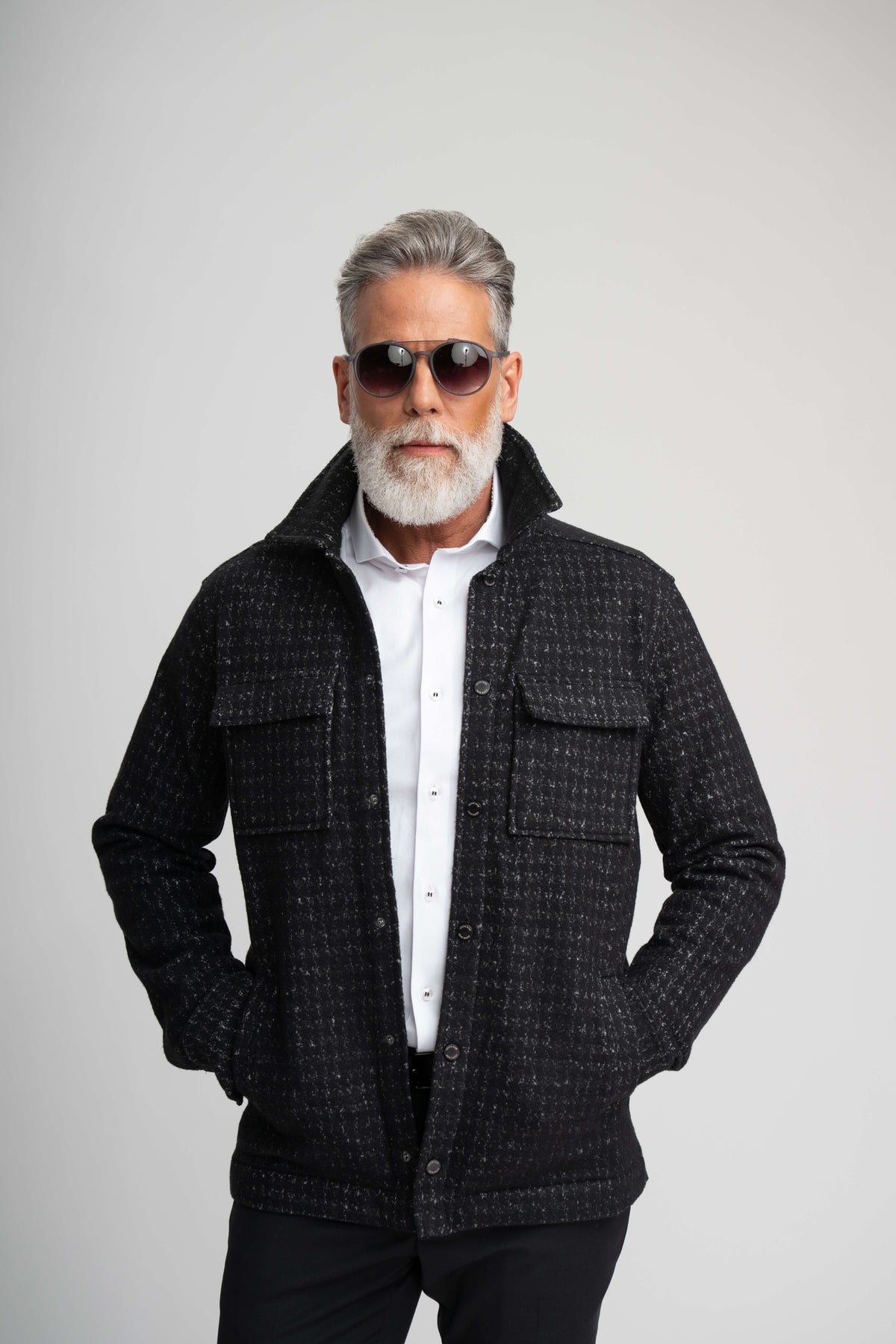 A man with a gray beard and sunglasses wears a Stone Rose Hunter Knit Houndstooth Jacket in black over a white collared shirt.