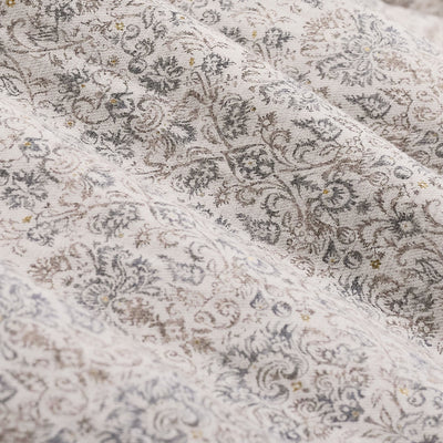 Close-up of the Bugatchi Axel Paisley Sport Shirt KS3132L40S, featuring finely woven fabric with an intricate paisley print in subtle gray and brown hues, highlighted by gentle folds and a soft texture—ideal for an elegant long-sleeve shirt from Bugatchi.