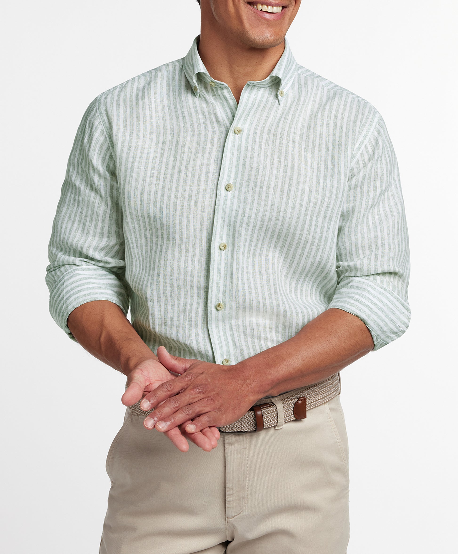 Man wearing a David Donahue Linen Stripe Sport Shirt CBBD12955335 in sage and white stripes with rolled sleeves, paired with beige pants, shown from shoulders to waist.