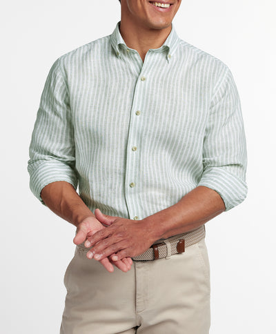 Man wearing a David Donahue Linen Stripe Sport Shirt CBBD12955335 in sage and white stripes with rolled sleeves, paired with beige pants, shown from shoulders to waist.